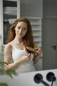 Portrait of young woman using mobile phone