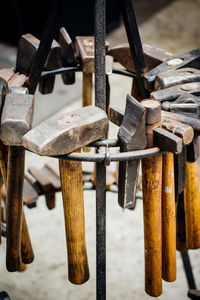 High angle view of various hammers hanging from rack at workshop