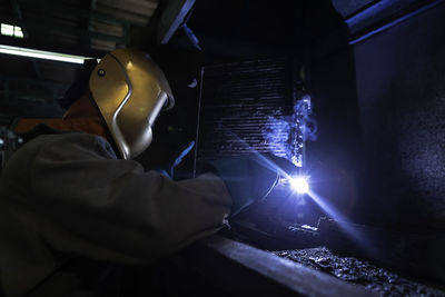 Man working in illuminated factory