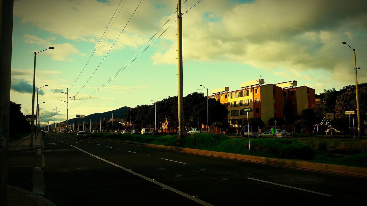 VIEW OF ROAD AGAINST CLOUDY SKY