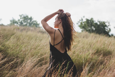 Woman standing on grassy field