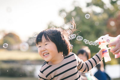 Portrait of happy woman with bubbles