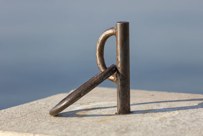 Close-up of rusty metal on beach