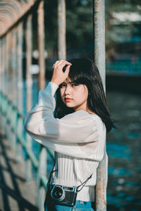 Portrait of beautiful young woman standing outdoors