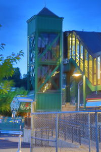 Illuminated building against sky