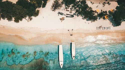 High angle view of boats moored at beach during sunny day