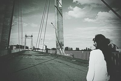 Woman standing on bridge in city