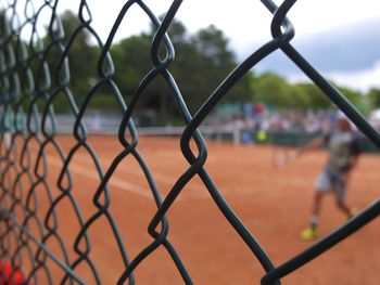 Tennis court seen through chainlink fence