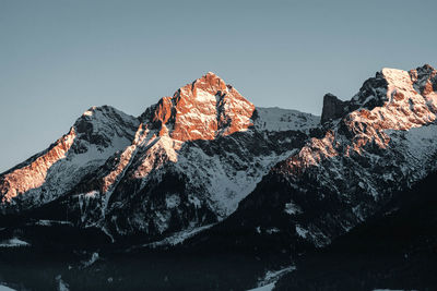 Scenic view of snowcapped mountains against clear sky