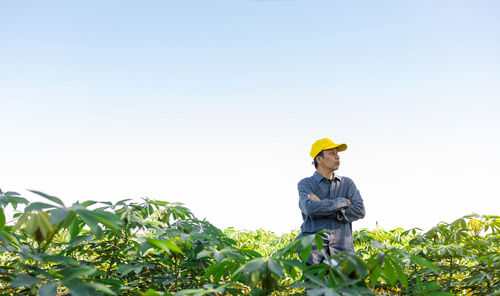 Man working on field against clear sky