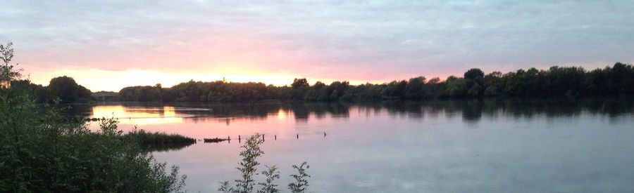 Scenic view of lake at sunset