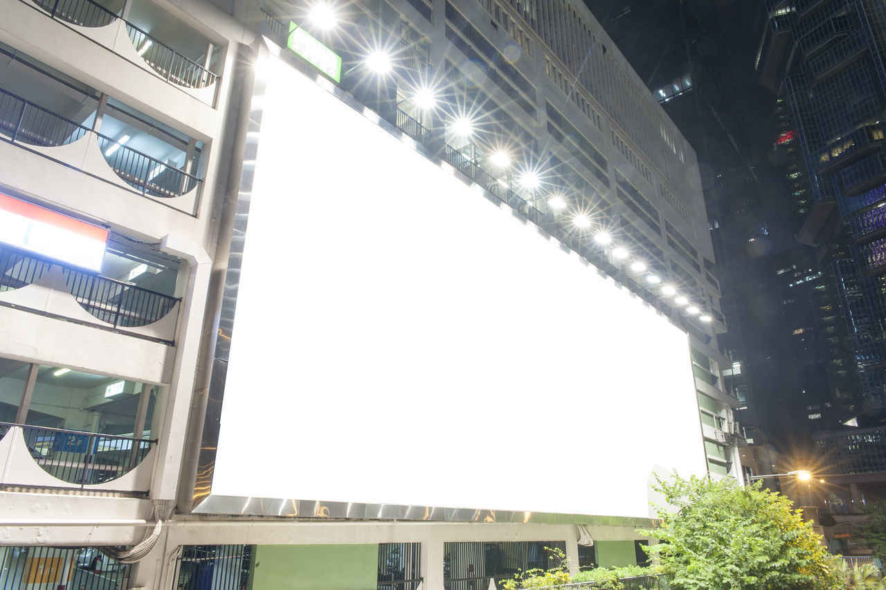 LOW ANGLE VIEW OF ILLUMINATED BUILDINGS AGAINST SKY