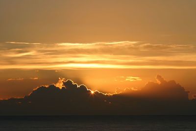 Scenic view of sea against romantic sky at sunset