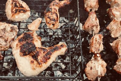 High angle view of meat on barbecue grill