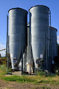 Metallic structure on field against sky