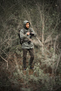 Full length of man standing in forest