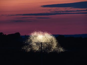 Low angle view of firework display at night