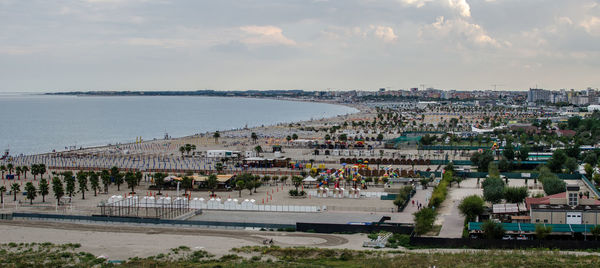 High angle view of beach by buildings against sky