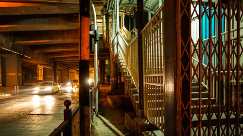 Steps by bridge in city at night