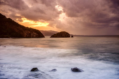 Scenic view of sea against cloudy sky