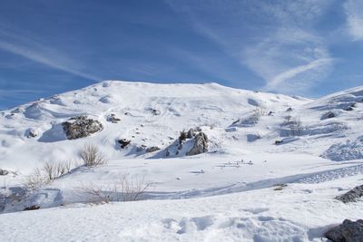 Scenic view of snow covered mountains against sky