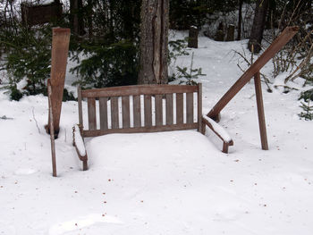 Wooden fence on snow covered field