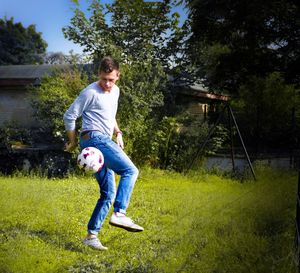 Full length of man playing with ball in yard