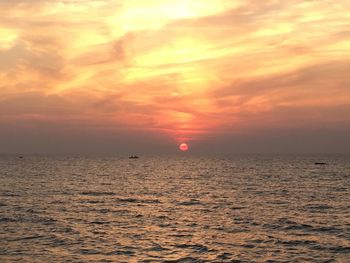 Scenic view of sea against orange sky