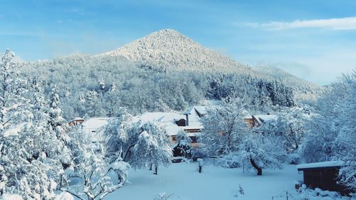 People on snow covered mountain against sky