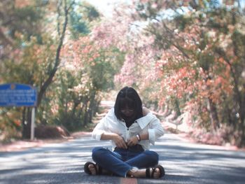 Portrait of man sitting on road