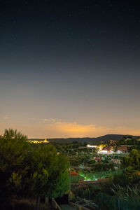 Aerial view of illuminated city against sky at night