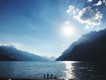 Scenic view of sea and mountains against sky
