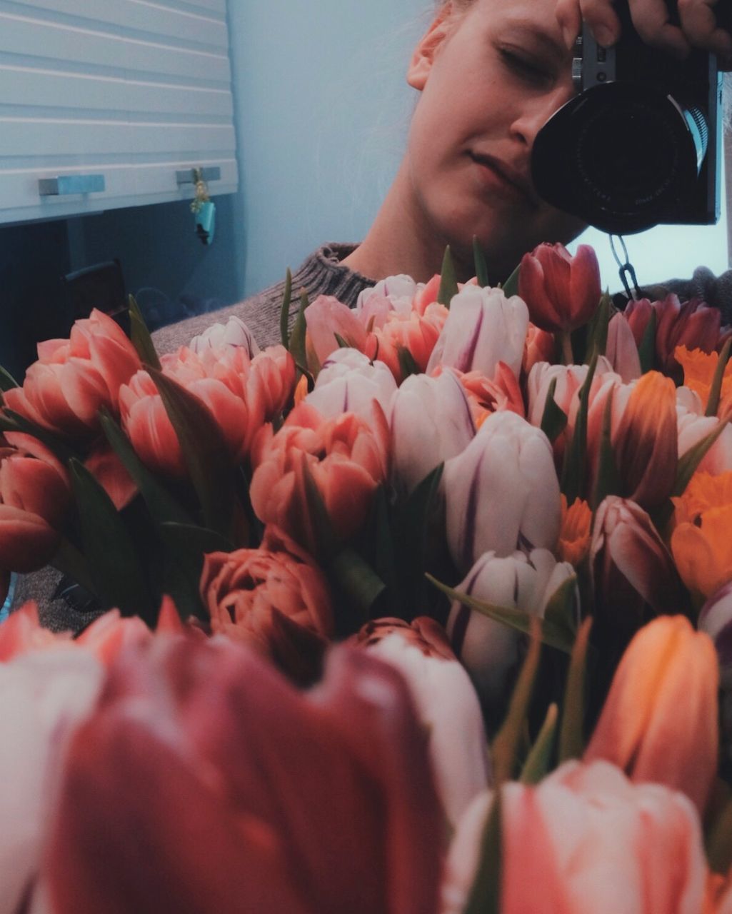 CLOSE-UP OF WOMAN WITH PINK FLOWER