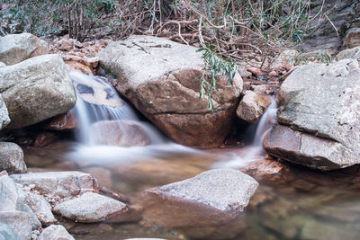 Stream flowing through rocks in forest