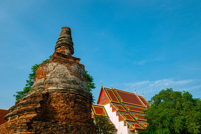 Low angle view of old building against blue sky