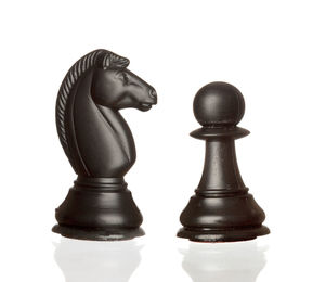 Close-up of chess pieces against white background