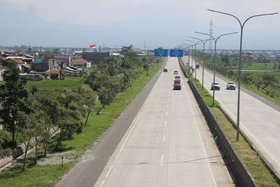 High angle view of road by city against sky
