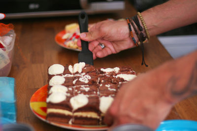 Cropped image of man serving birthday cake