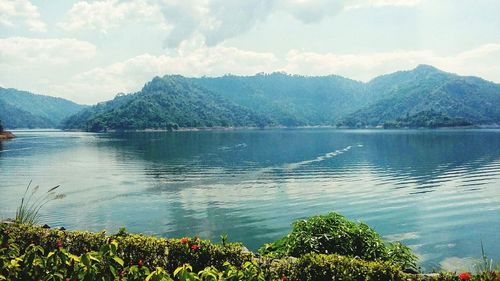 Scenic view of lake and mountains against sky