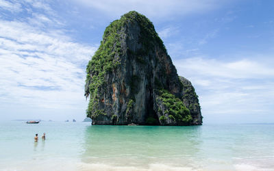 Scenic view of rock formation in sea against sky