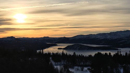 Scenic view of silhouette mountains against sky during sunset