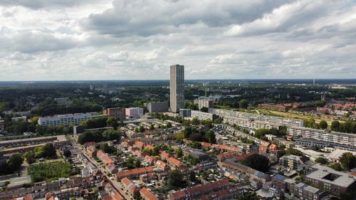 High angle view of cityscape against cloudy sky