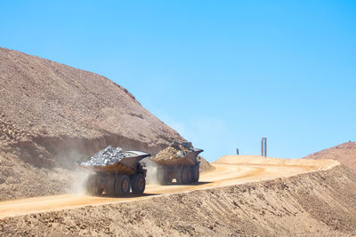 Huge dump trucks loaded with mineral in a copper mine in chile.
