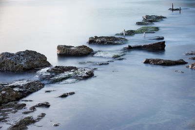 Rocks on beach against sky