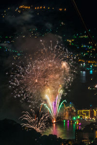 Low angle view of firework display in city at night