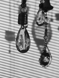 Close-up of electric lamp hanging on shadow