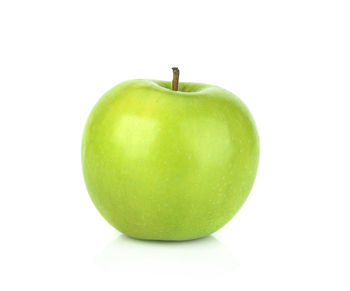 Close-up of fresh green apple against white background