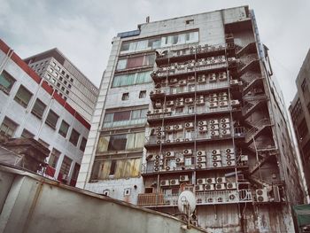 Low angle view of buildings in city against sky