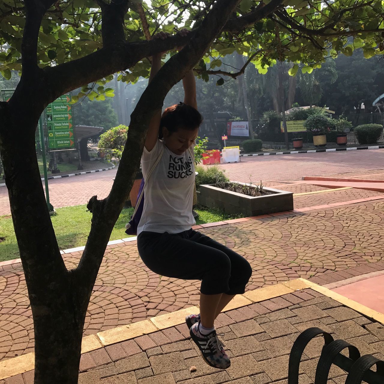 real people, tree, lifestyles, one person, arms raised, full length, leisure activity, young women, balance, young adult, exercising, day, outdoors, sunlight, women, architecture, healthy lifestyle, nature