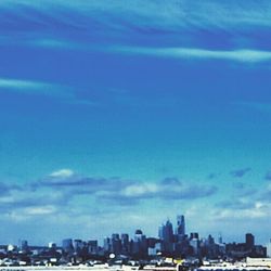 View of cityscape against cloudy sky
